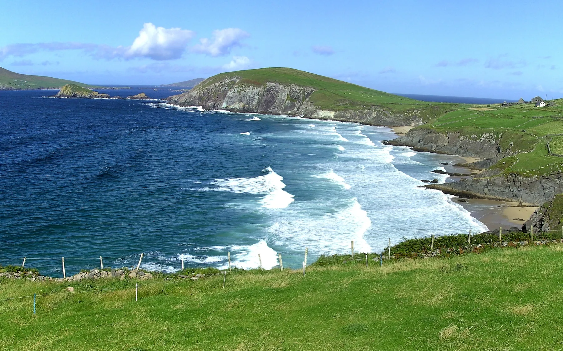 Green fields and a winding road above the sea on the Dingle Peninsula