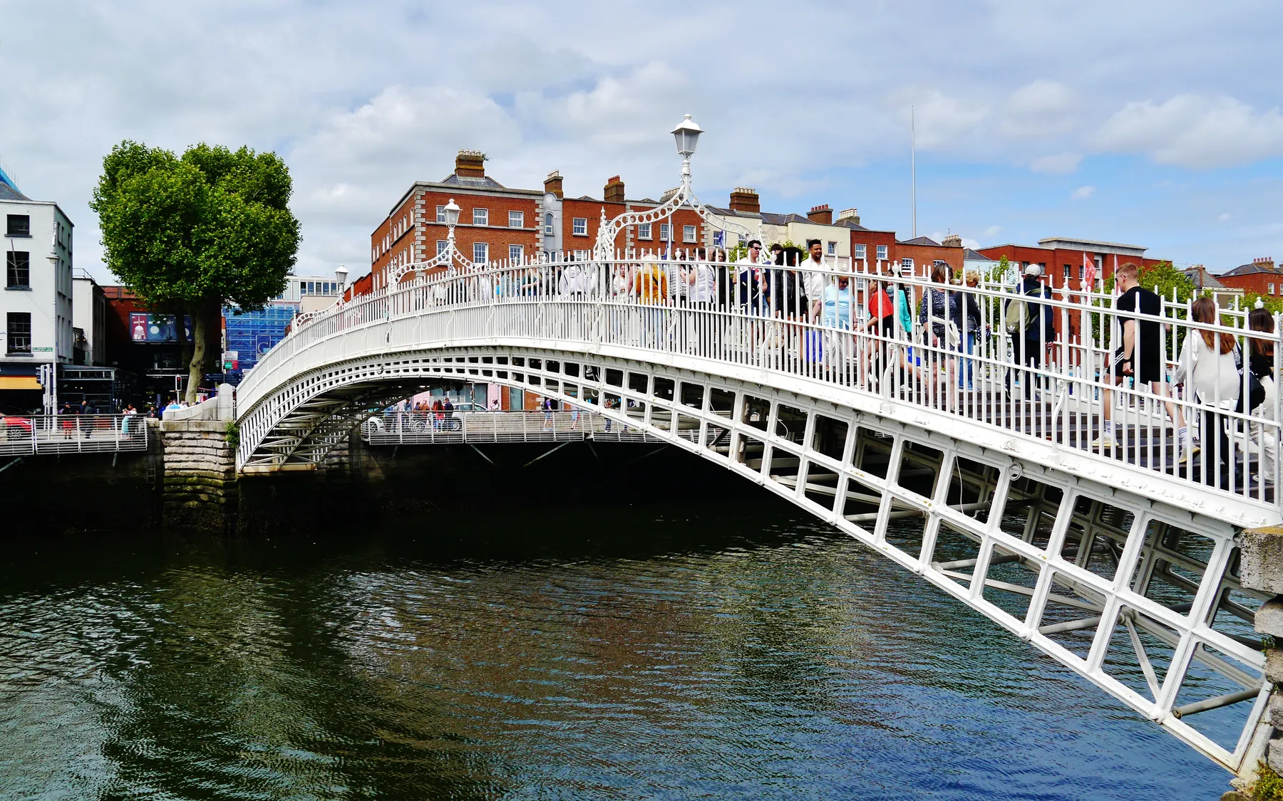 The white Ha’penny Bridge crossing the River Liffey in central Dublin
